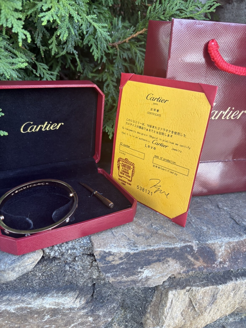 Cartier gold and black Love bracelet with red presentation box